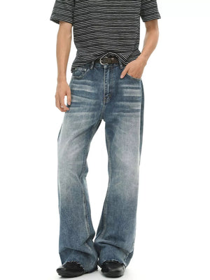 Men's blue denim flare jeans with a faded wash and distressed details.