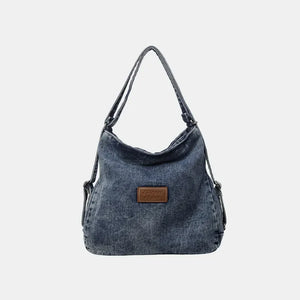 Denim hobo bag with leatherette patch in medium wash.