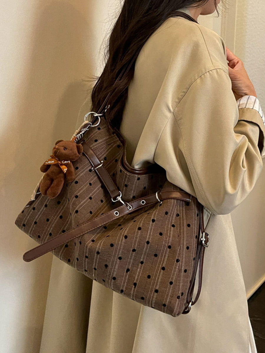 handbag in Light Blue with polka dot, striped and buckle straps