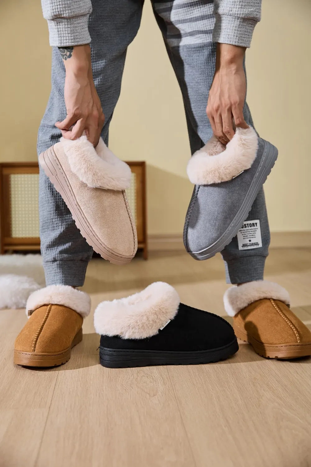Suede shearling-trimmed house slippers in black, caramel, gray, and khaki.