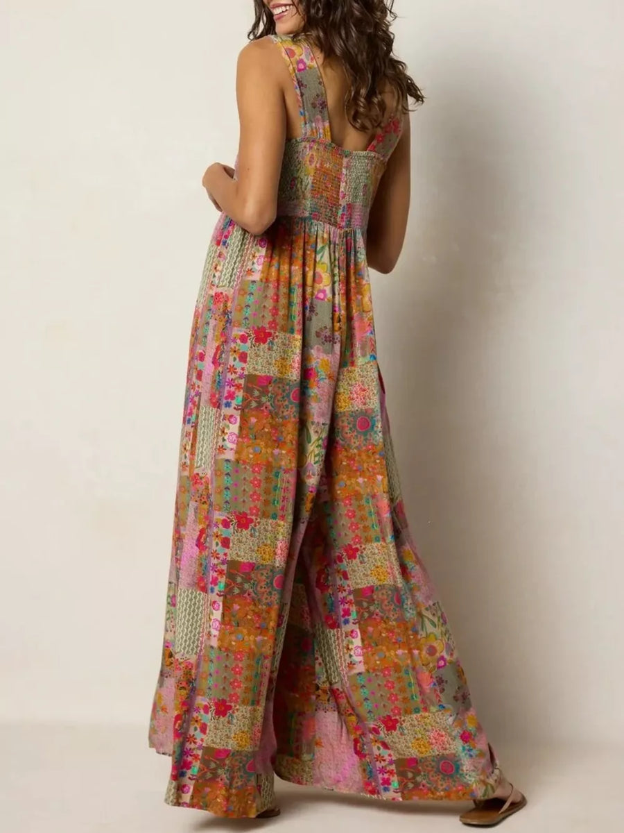 Vibrant patchwork wide-leg romper with smocked bodice and square neckline.