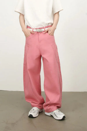 Dusty pink wide leg trousers with sculpted pocket details and a white belt.