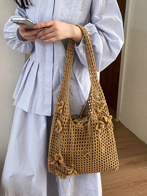 Khaki handbag featuring crochet construction and floral