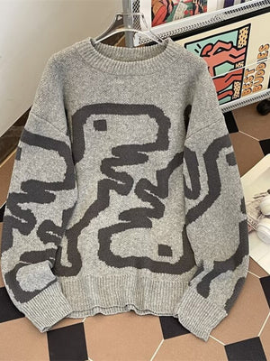 Grey knit sweater with dark abstract graphic print and crew neck