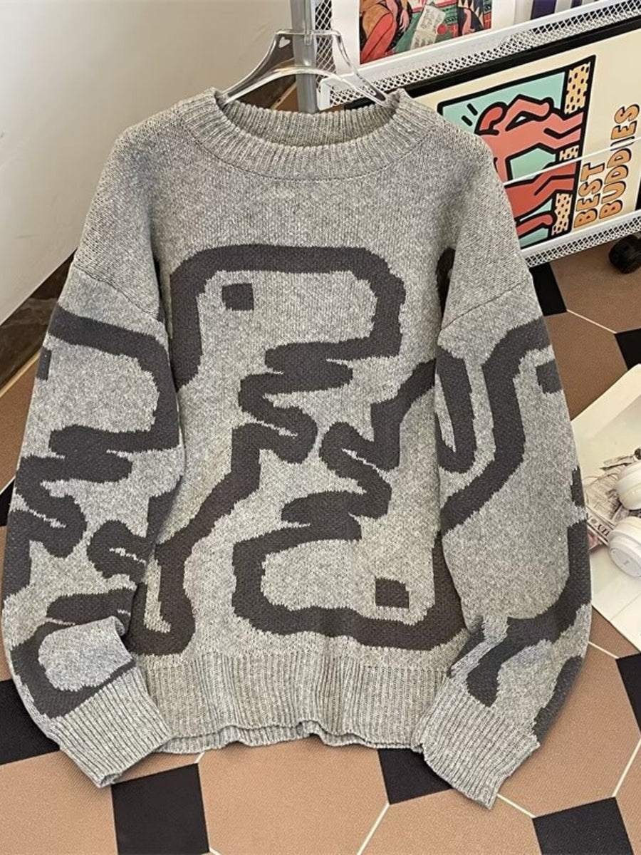 Grey knit sweater with dark abstract graphic print and crew neck
