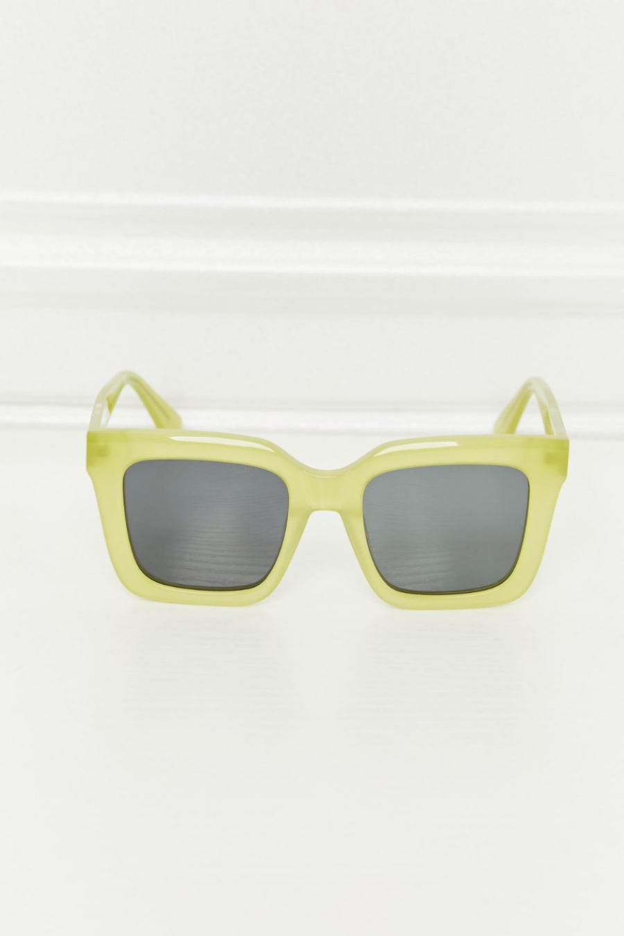 Citron box frame sunglasses with dark lenses and acetate frames.