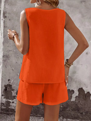Orange cotton two-piece set with sleeveless top and shorts, featuring decorative buttons.