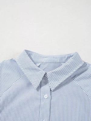 Blue and white striped collared button-up shirt with a classic collar and button detail.