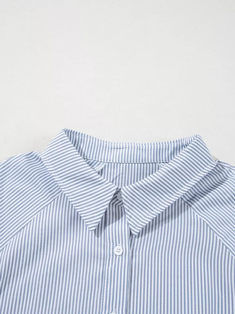 Blue and white striped collared button-up shirt with a classic collar and button detail.