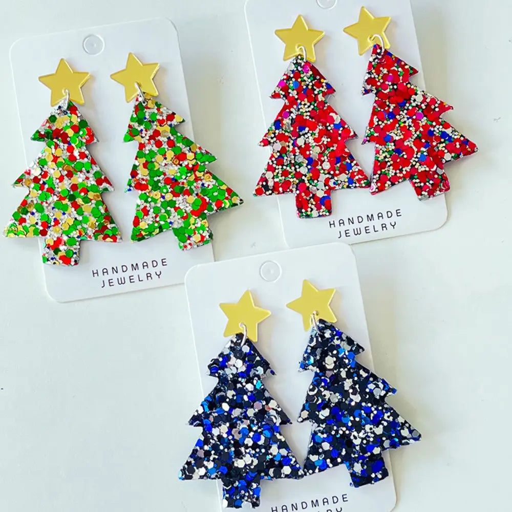 Glittered Christmas tree statement earrings with gold stars, available in green, red, and dark blue acrylic.