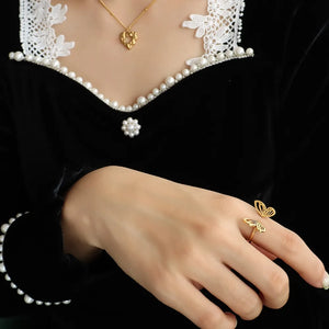 Gold butterfly wing open-ended ring on a woman's finger