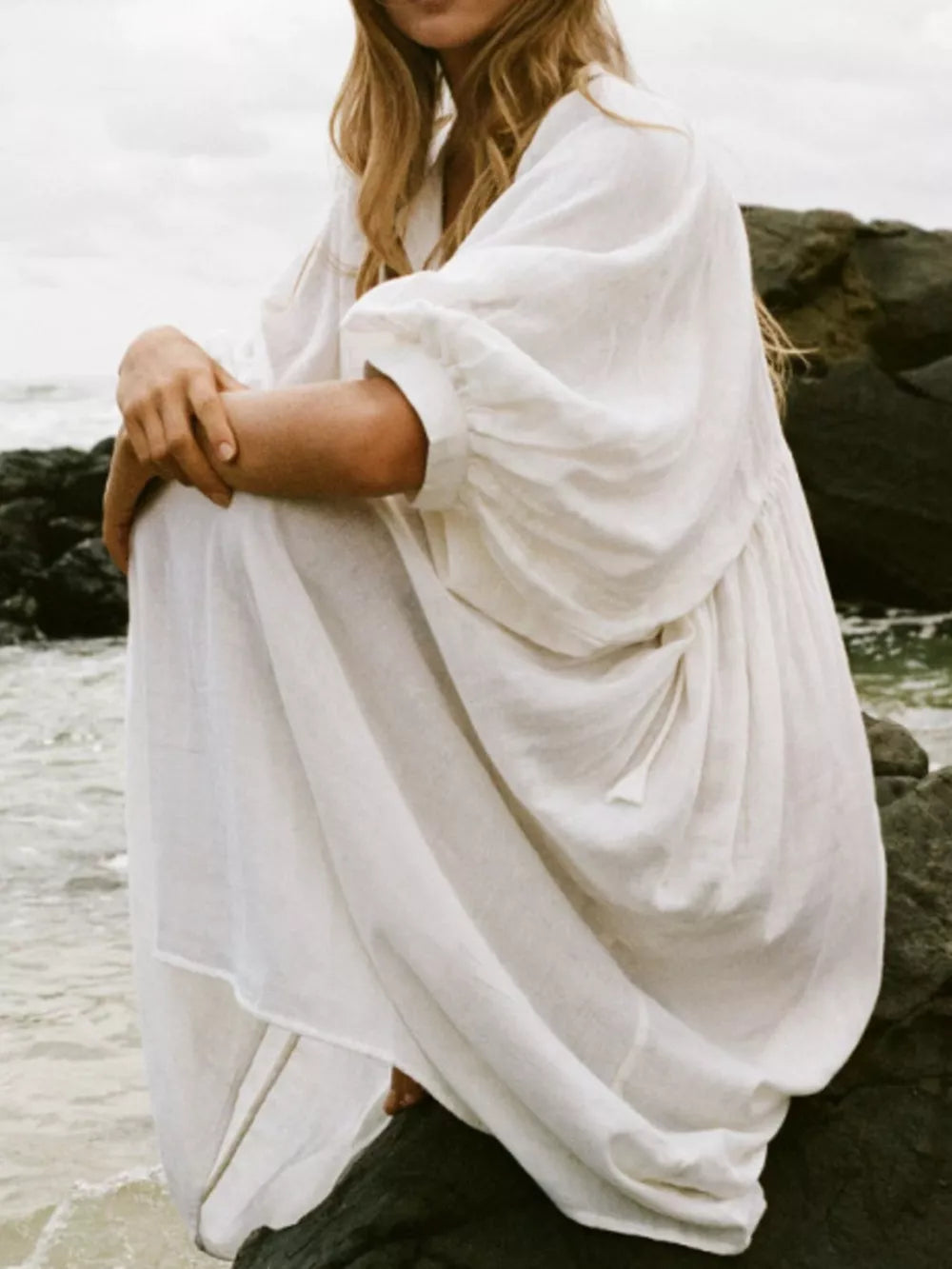 White tie-neck midi dress with puff sleeves and a flowing skirt.