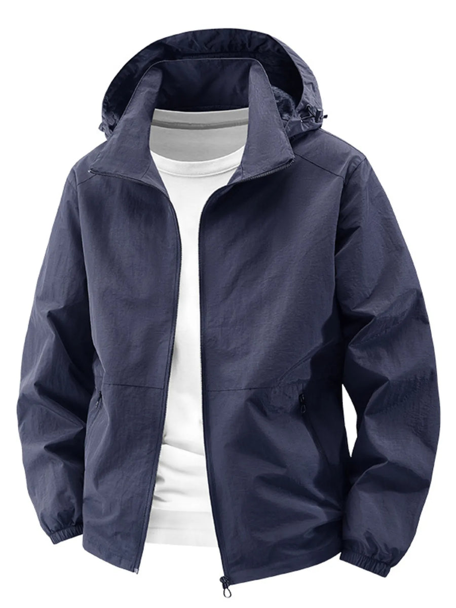 Dark blue hooded windbreaker jacket with zipper and pockets, worn over a white t-shirt.