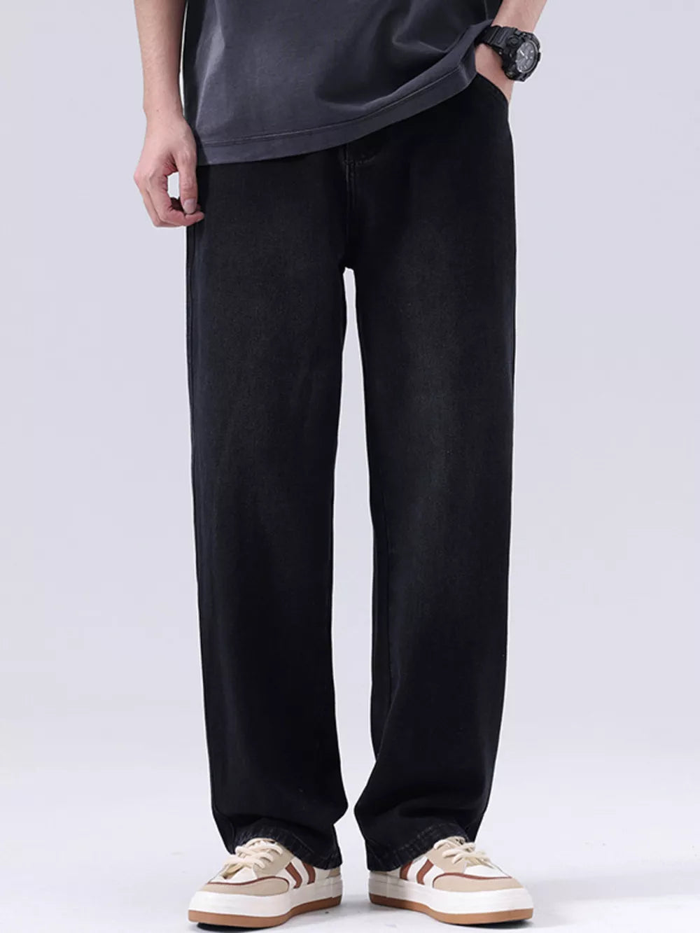 Men's black vintage wash loose fit cotton jeans with a relaxed cut.