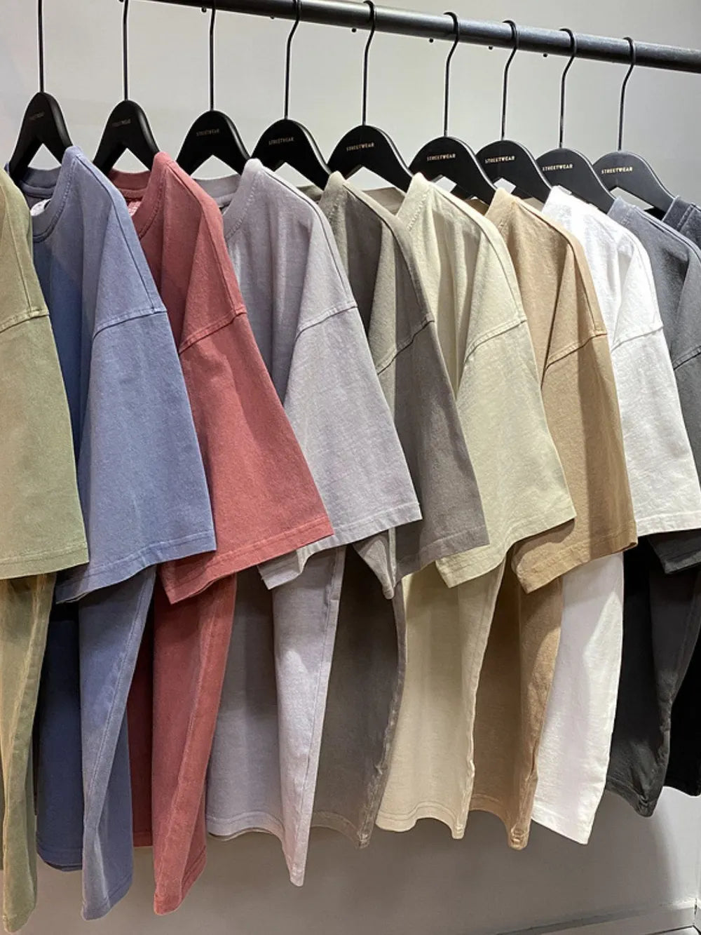 Oversized washed cotton tee in relaxed fit, available in multiple earth tones and neutrals.