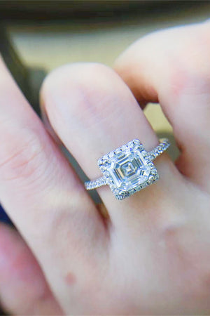 Silver Asscher cut moissanite halo ring with a pavé band.