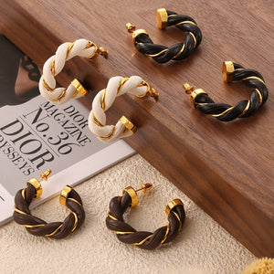 Braided leather and gold hoop earrings in black, white, and coffee brown.