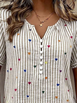 light brown blouse featuring decorative button and striped