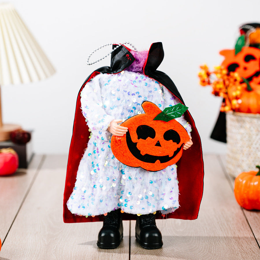 Doll with white sequin dress, red cape, and holding a felt pumpkin.