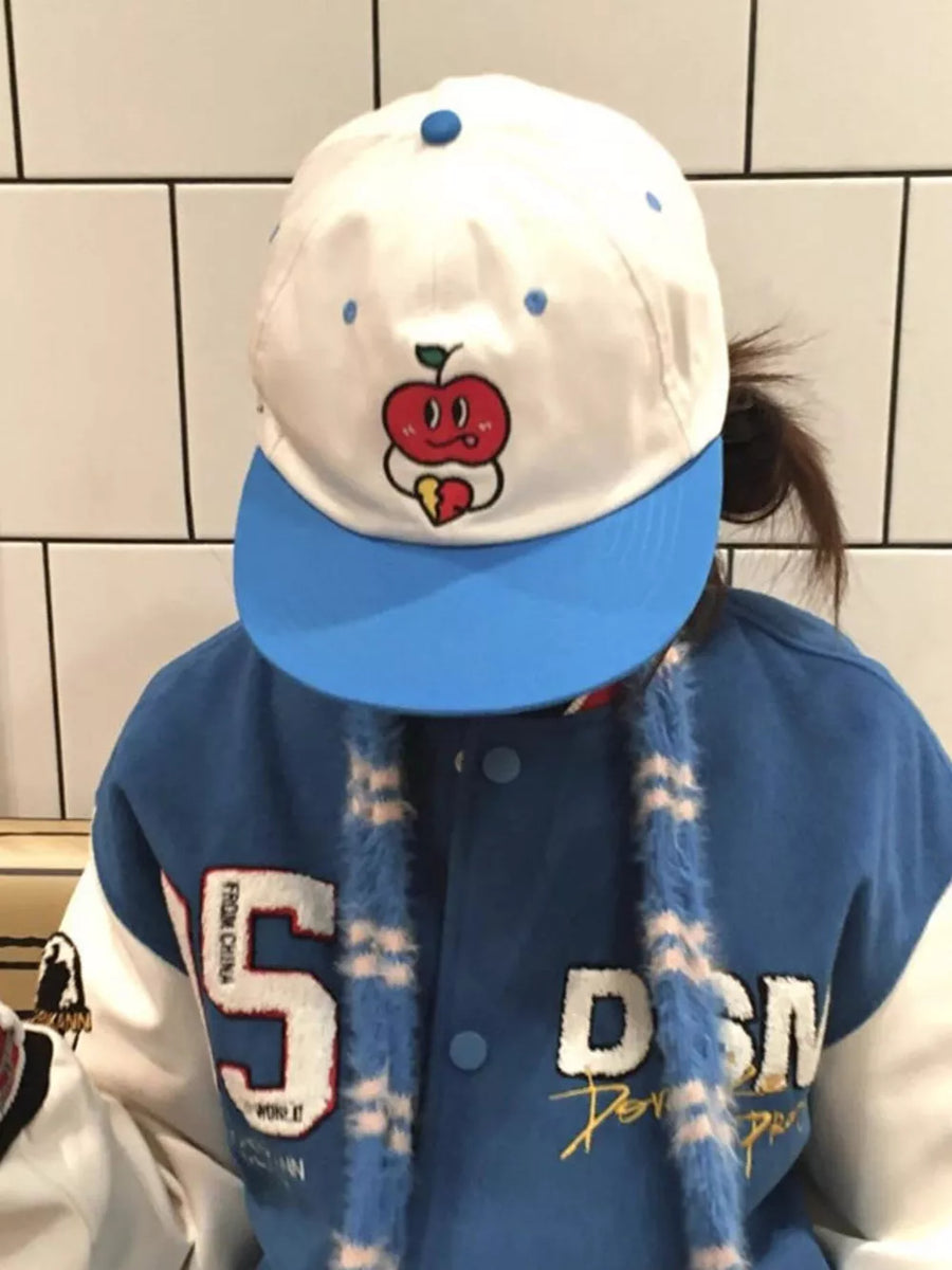 White baseball cap with blue brim and embroidered apple graphic.