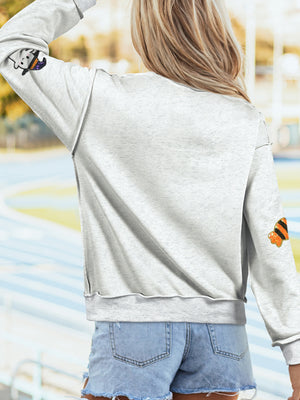 100% polyester Care instructions: Machine wash cold sweatshirt in orange with relaxed silhouette