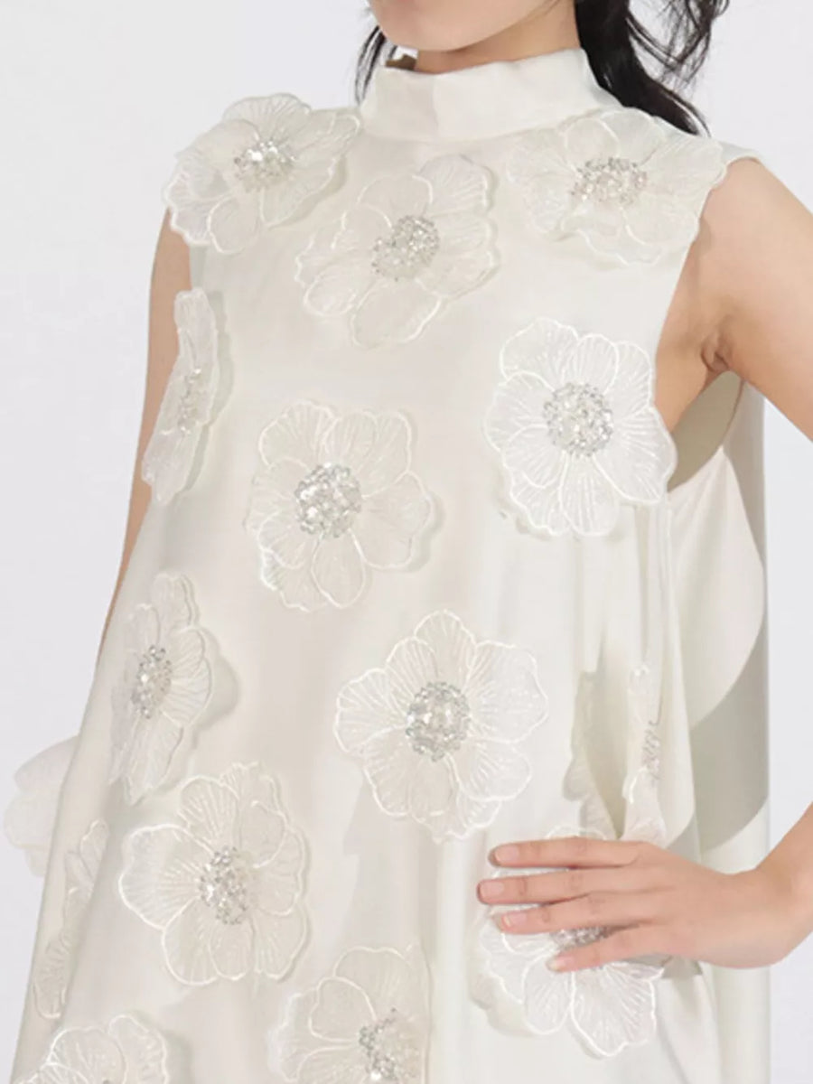 White sleeveless mock neck dress with embroidered floral appliques and crystal embellishments