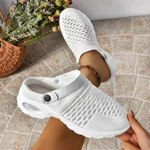White knit sport clogs with perforated details and a heel strap.