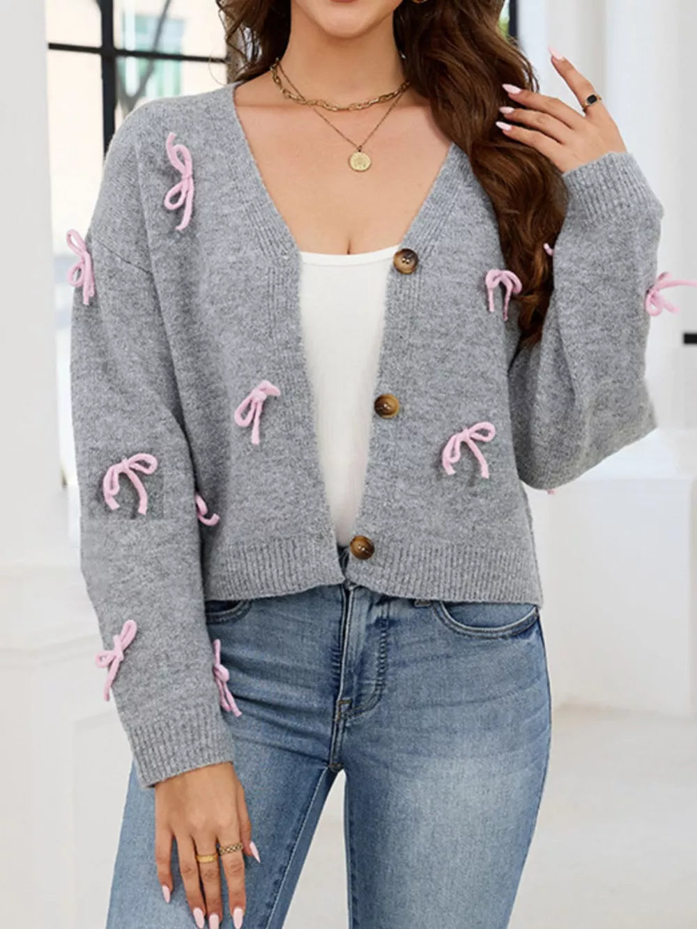cardigan in heather gray featuring bows and relaxed fit