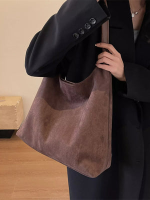 Women's casual suede shoulder bag in brown, with a slouchy silhouette and leather trim.