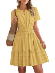 Yellow textured V-neck tiered dress with smocked waist and short sleeves