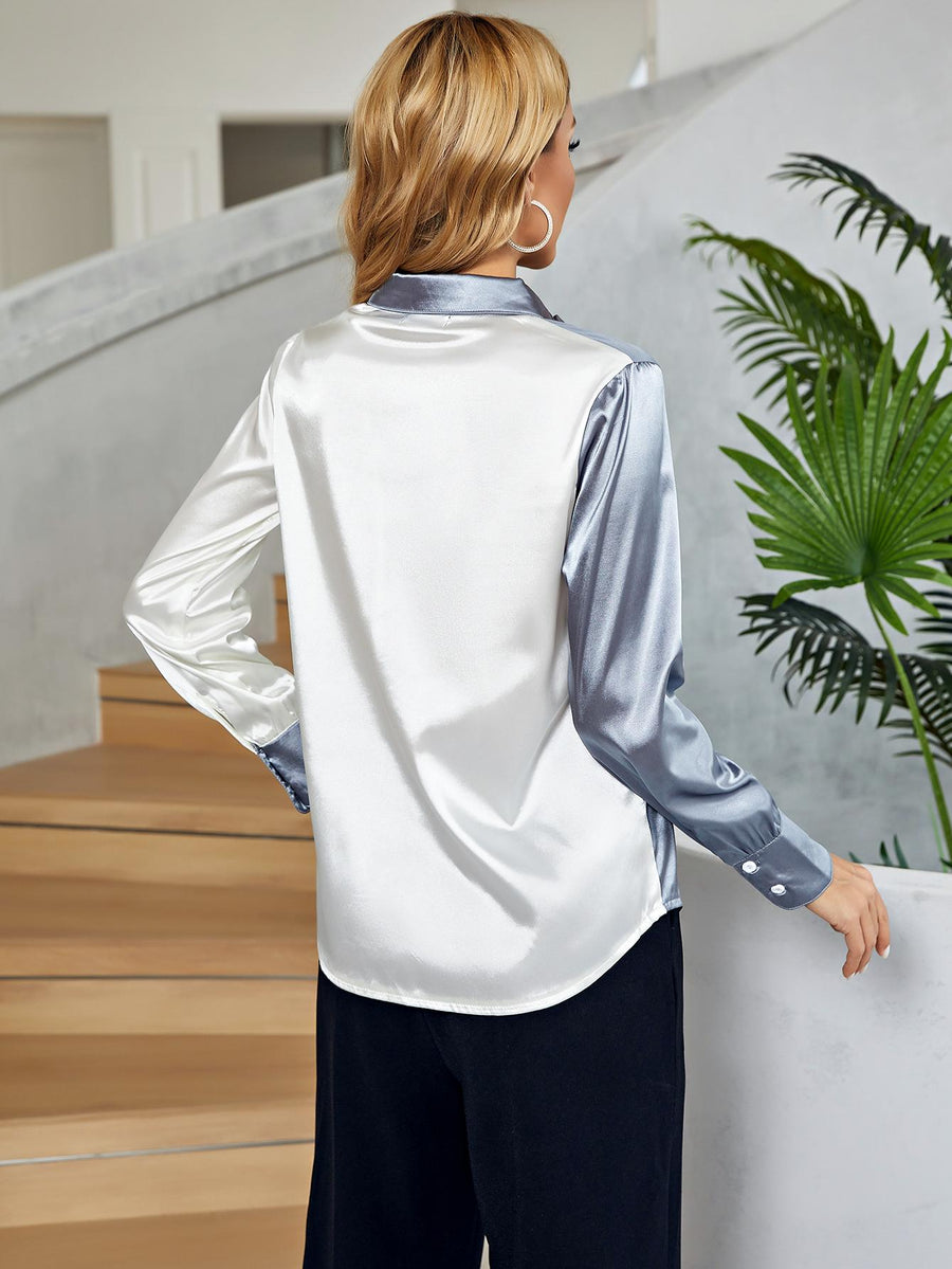 Satin colorblock button-down blouse in white and light blue with button cuffs.