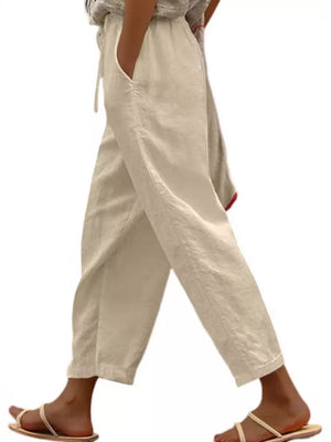 Relaxed fit cropped maternity pants in white with drawstring and pockets.
