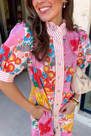 Maxi dress with vibrant floral print, pink stripes, button front, and ruffled collar.