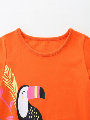Orange cotton toddler dress with toucan print and round neckline.