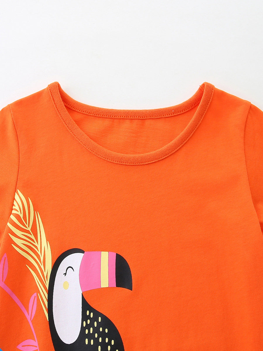 Orange cotton toddler dress with toucan print and round neckline.