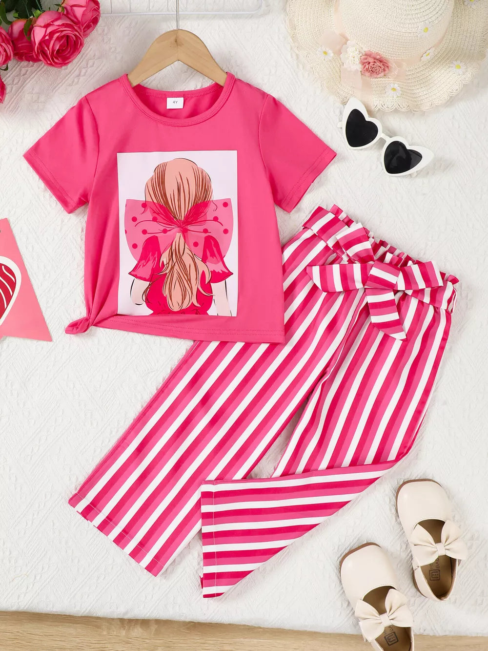 Pink bowknot graphic tee with knotted hem and pink striped pants with bow detail
