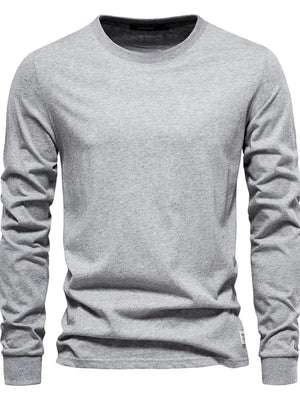 Gray crewneck long sleeve t-shirt with a relaxed fit and a small white tag detail on the hem.