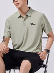 Green short-sleeve polo shirt with button detail and embroidered text.