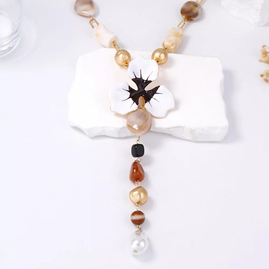 white necklace featuring Y-shaped and floral