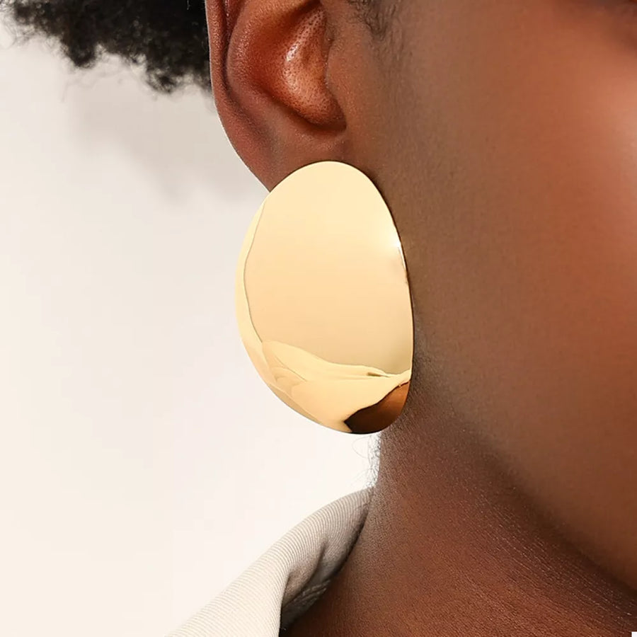 earrings in gold with curved design and 2 inches