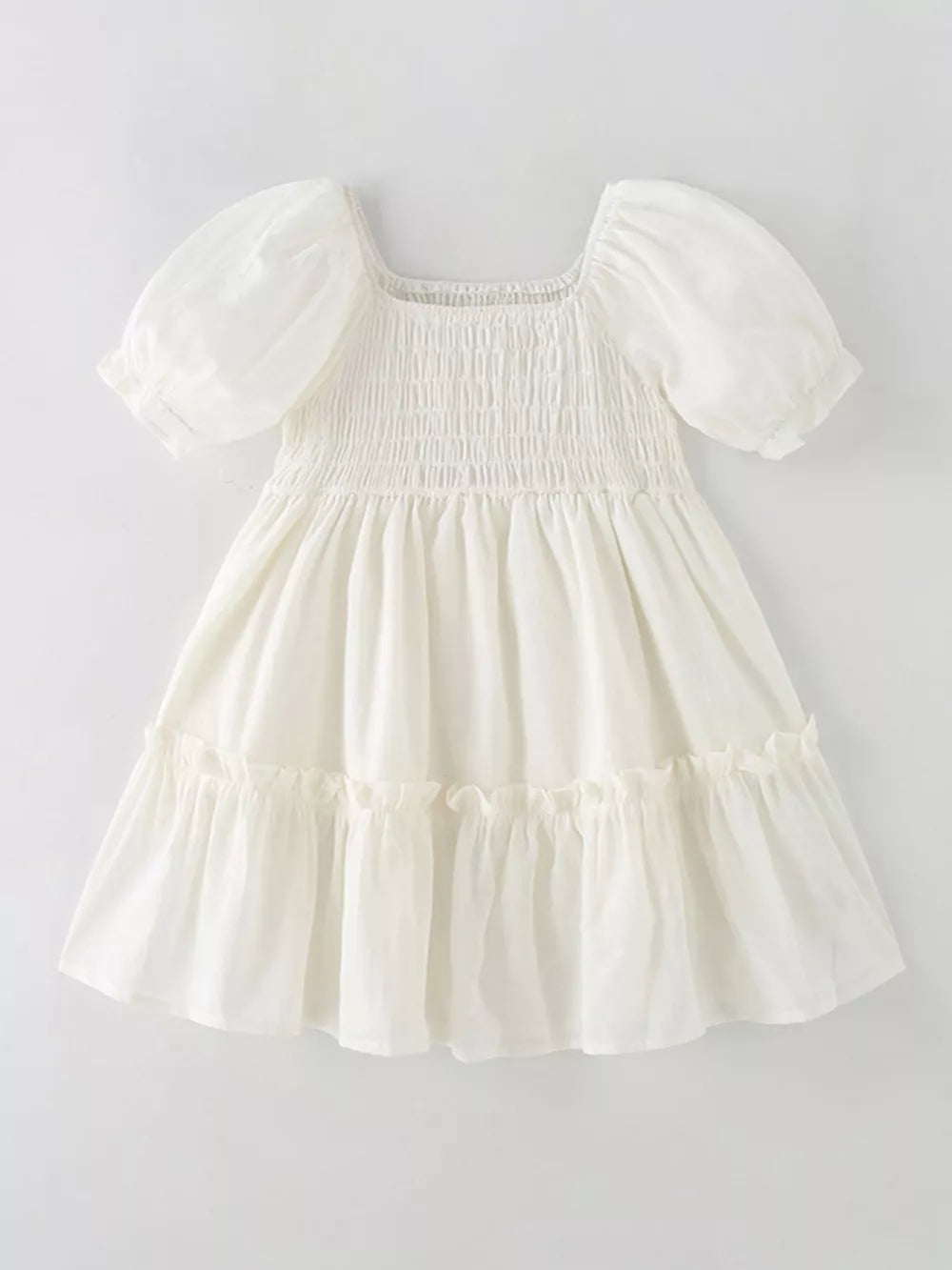 Cream cotton blend toddler dress with puff sleeves, square neckline, smocked bodice, and tiered ruffle skirt.