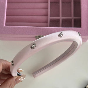 Pink satin padded headband with silver bow embellishments