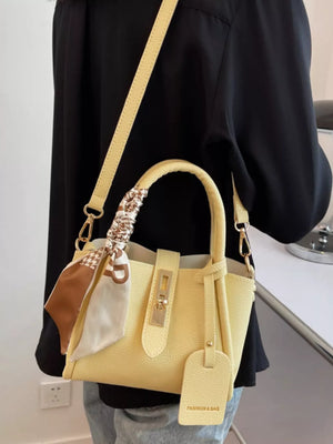 Yellow mini crossbody bag with scarf detail and gold hardware