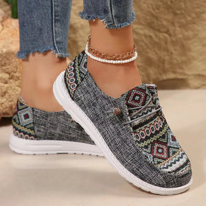 Gray canvas slip-on flats with embroidered geometric pattern and rope detail