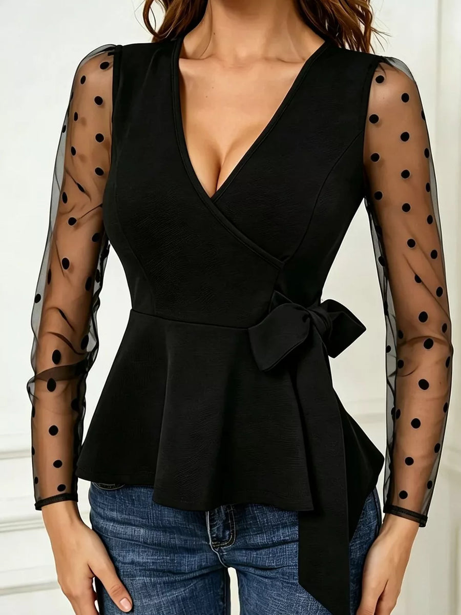 Black peplum top featuring mesh and polka-dot