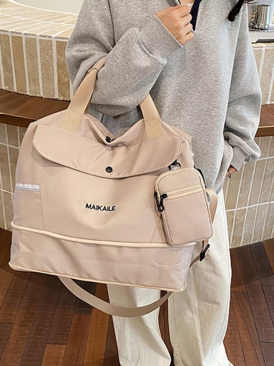 Beige duffel bag with MAIKAILE logo and detachable pouch, styled with a grey hoodie.