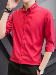 Red cotton button-down shirt with contrasting buttons and embroidered collar detail.