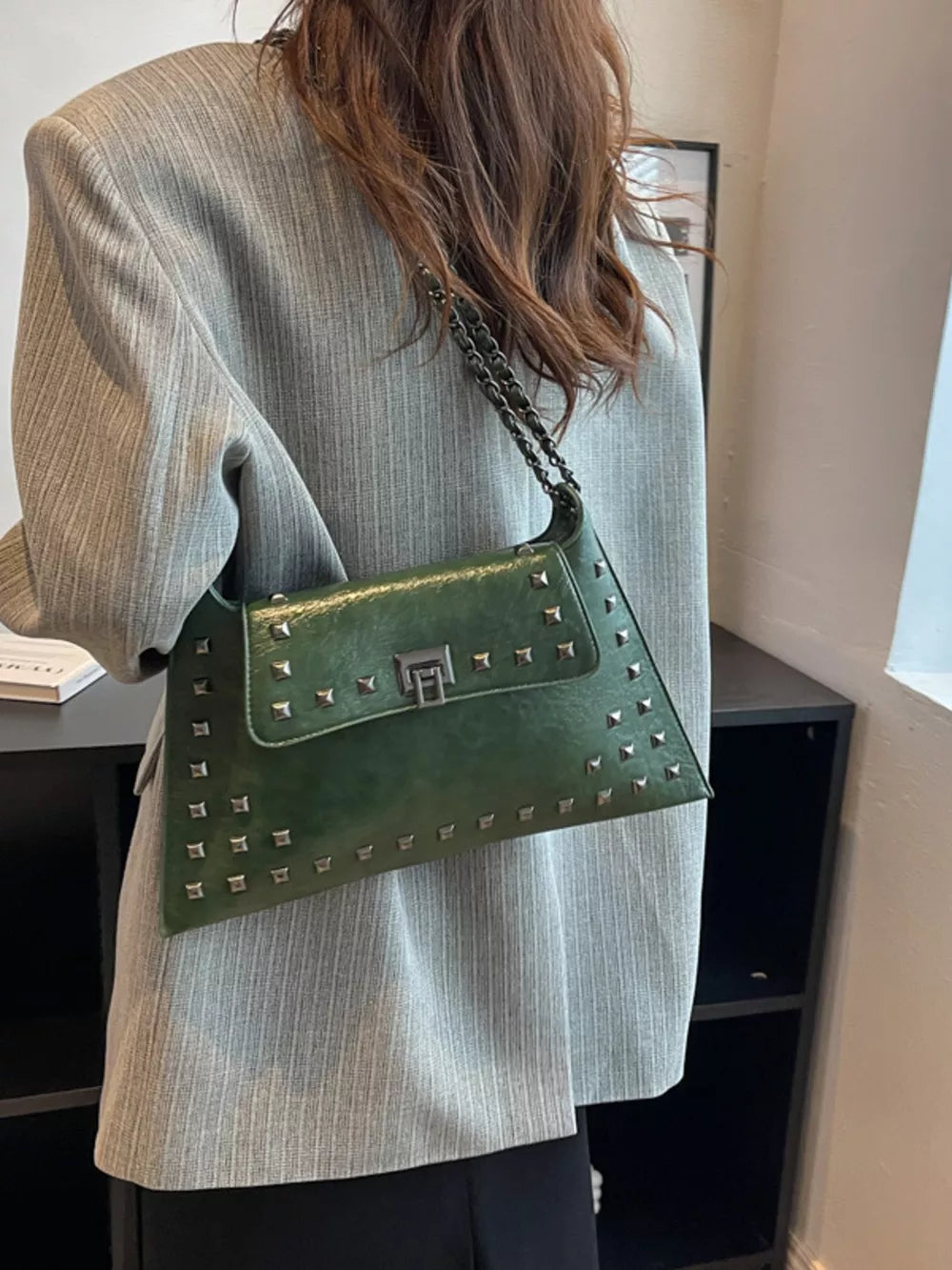 Green embellished chain flap shoulder bag with silver studs and clasp.