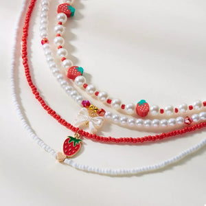 red necklace featuring beaded and novelty
