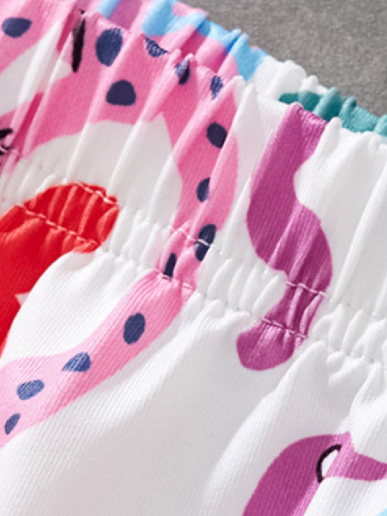 Toddler shorts with elastic waistband and colorful animal print pattern.